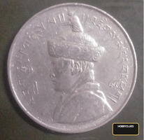 Vintage Tibetan Silver Coin with Traditional Symbols and Portrait
