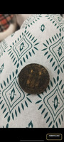 Collectible Coin with Standing Figure and Architectural Design