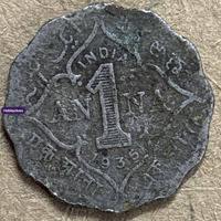 Old Collectible Coin with Central Emblem and Decorative Script